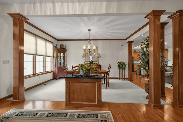 12372 Brook Forest Cir NW, Pickerington, OH 43147 - dining area featuring baseboards, a notable chandelier, ornamental molding, light wood-type flooring, and decorative columns