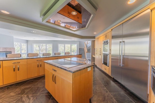 kitchen featuring a kitchen island, stainless steel appliances, recessed lighting, and marble finish floor