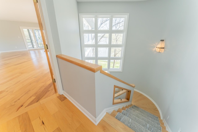 stairway featuring baseboards and wood finished floors