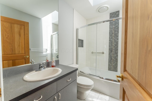 full bath with vanity, enclosed tub / shower combo, toilet, and tile patterned flooring