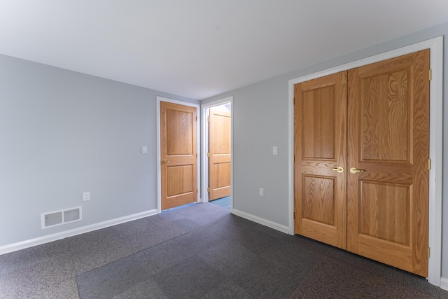 unfurnished bedroom with baseboards and visible vents