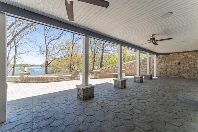 view of patio / terrace featuring a water view and ceiling fan