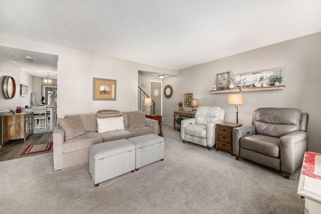 living room featuring stairs and carpet