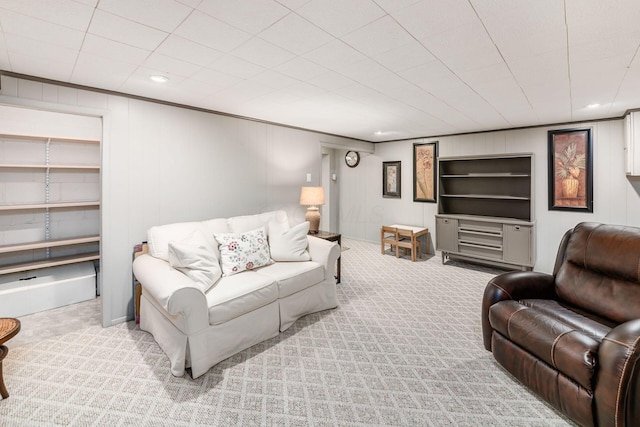 carpeted living room featuring recessed lighting and a decorative wall