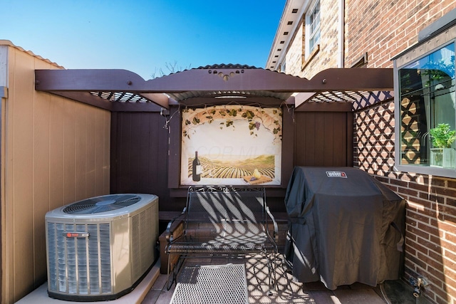 view of patio with central air condition unit and a grill