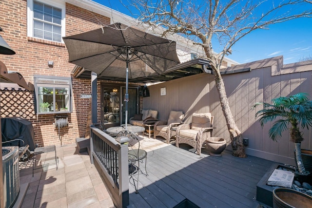 deck with grilling area, outdoor lounge area, and central AC unit