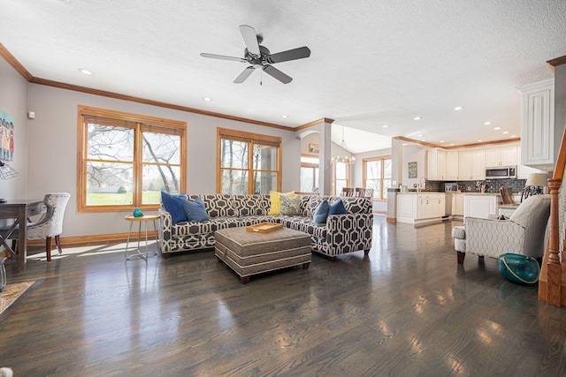 6707 Meadow Glen Dr S, Westerville, OH 43082 - living area with crown molding, a textured ceiling, ceiling fan with notable chandelier, baseboards, and dark wood-style floors