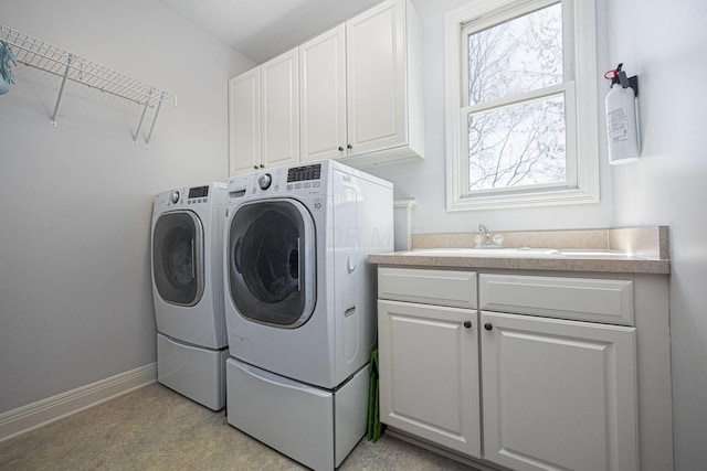 6707 Meadow Glen Dr S, Westerville, OH 43082 - laundry area with baseboards, a sink, washer and clothes dryer, and cabinet space