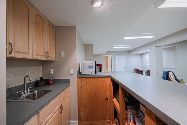6707 Meadow Glen Dr S, Westerville, OH 43082 - kitchen featuring light brown cabinetry, a sink, white microwave, and a textured ceiling