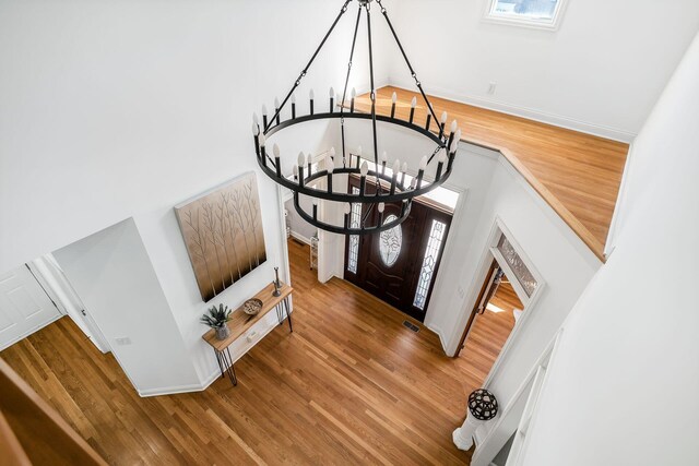 478 Riverbend Ave, Powell, OH 43065 - foyer with wood finished floors, visible vents, a towering ceiling, and an inviting chandelier