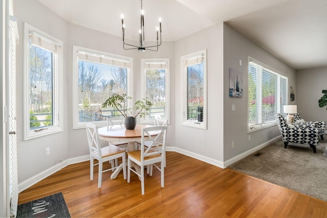 478 Riverbend Ave, Powell, OH 43065 - dining room with baseboards, wood finished floors, and an inviting chandelier