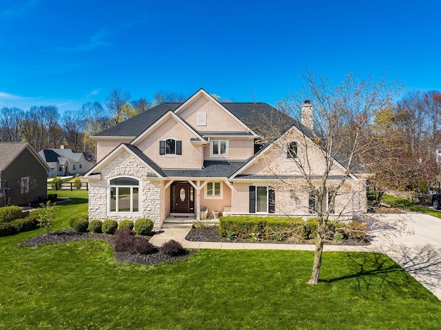 478 Riverbend Ave, Powell, OH 43065 - view of front of home featuring stucco siding, a front lawn, a chimney, and stone siding