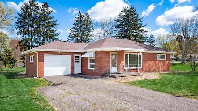 single story home with driveway, a porch, a front yard, and a garage