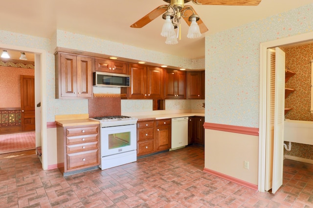 115 E Wheeling St, Lancaster, OH 43130 - kitchen featuring white appliances, wallpapered walls, brick patterned flooring, a ceiling fan, and light countertops
