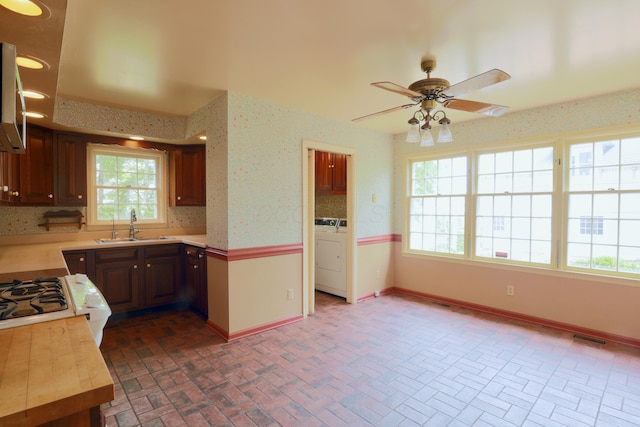 115 E Wheeling St, Lancaster, OH 43130 - kitchen with brick patterned floors, washer / clothes dryer, a ceiling fan, healthy amount of natural light, and wallpapered walls