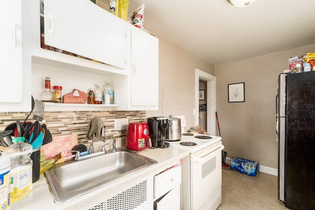 1282-1284 Linwood Ave, Columbus, OH 43206 - kitchen with a sink, tasteful backsplash, freestanding refrigerator, white cabinetry, and white electric stove