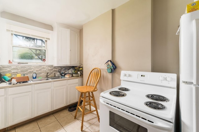1282-1284 Linwood Ave, Columbus, OH 43206 - kitchen featuring a sink, white appliances, decorative backsplash, light tile patterned floors, and white cabinets