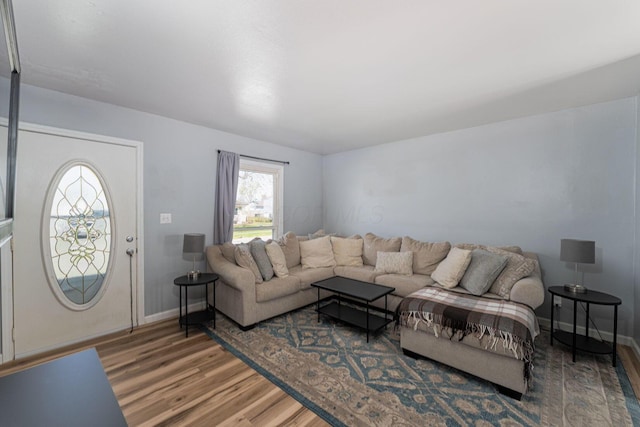 living room featuring baseboards and wood finished floors