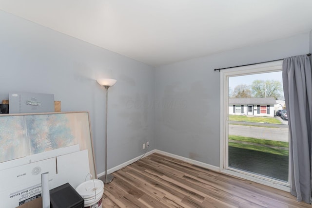 empty room with wood finished floors and baseboards