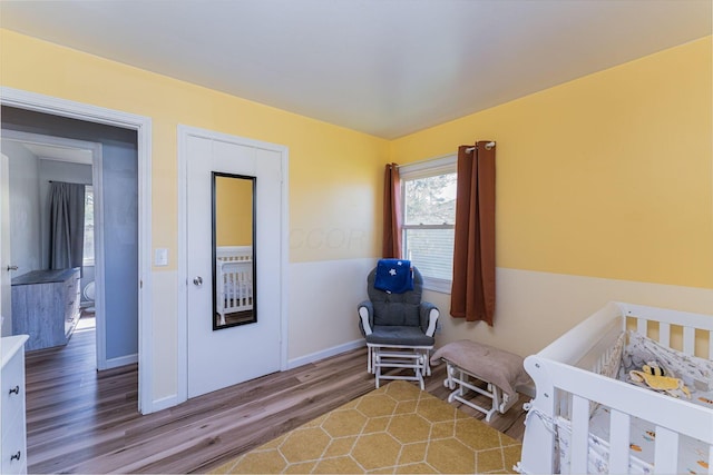 bedroom featuring baseboards and wood finished floors