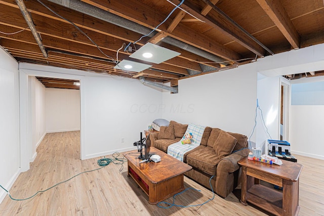 living room with baseboards and wood finished floors