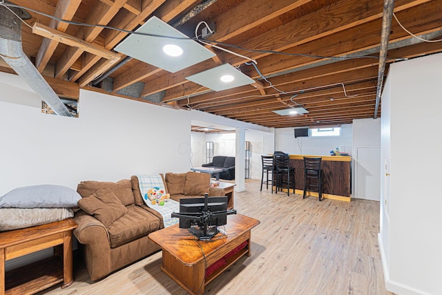 living room featuring wood finished floors and a bar