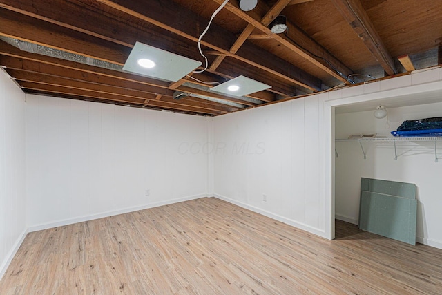 finished basement featuring baseboards and wood finished floors