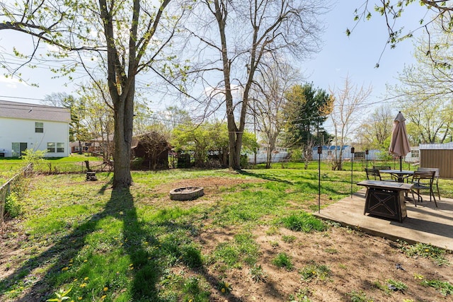 view of yard with a patio area, an outdoor fire pit, and fence