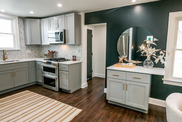 568 Cline St, Columbus, OH 43206 - kitchen with gray cabinetry, stainless steel appliances, dark wood-style floors, and a sink