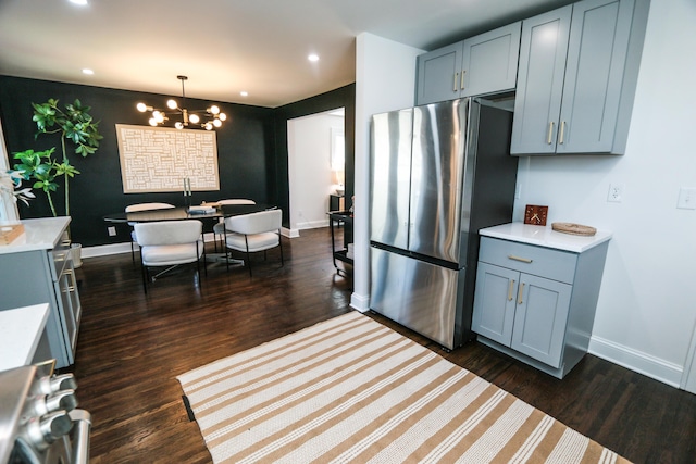 568 Cline St, Columbus, OH 43206 - kitchen with stove, freestanding refrigerator, light countertops, and gray cabinetry