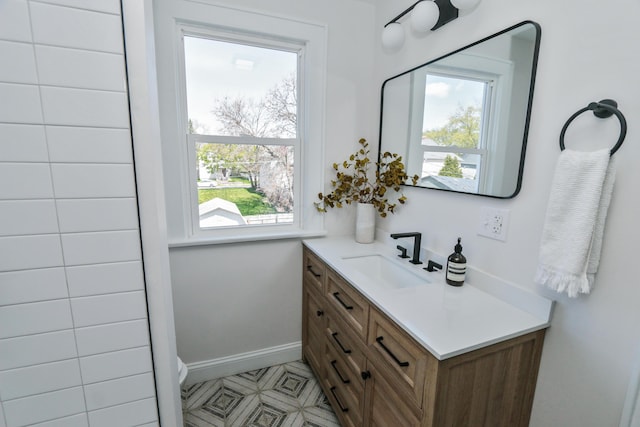 568 Cline St, Columbus, OH 43206 - bathroom featuring baseboards, vanity, tile patterned floors, and plenty of natural light