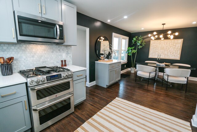 568 Cline St, Columbus, OH 43206 - kitchen with stainless steel appliances, light countertops, decorative backsplash, and a notable chandelier