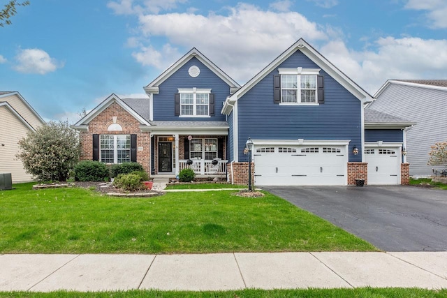 8181 Trail Lake Dr, Powell, OH 43065 - craftsman-style home featuring a front lawn, brick siding, aphalt driveway, and covered porch