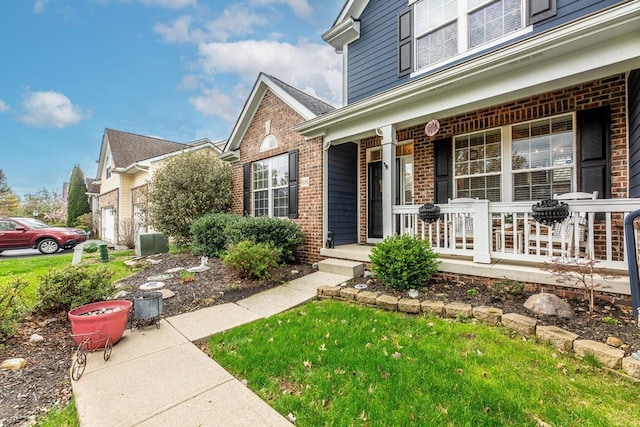 8181 Trail Lake Dr, Powell, OH 43065 - view of exterior entry featuring brick siding and a porch