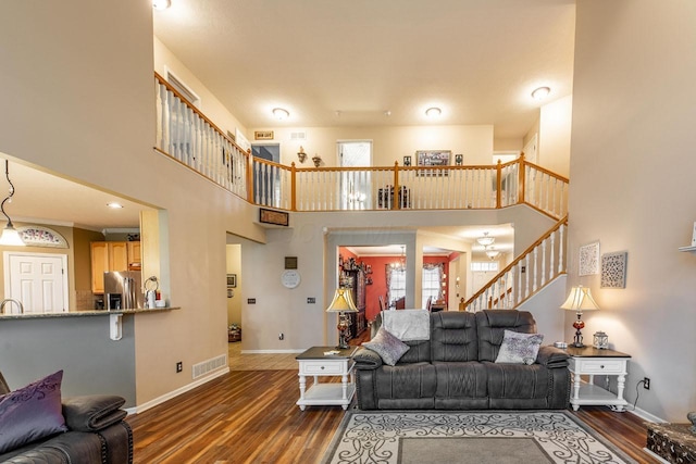 8181 Trail Lake Dr, Powell, OH 43065 - living room with a towering ceiling, baseboards, stairs, and dark wood-style flooring