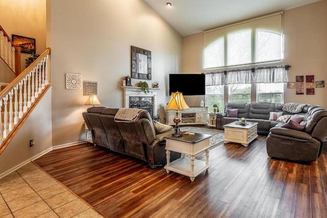 8181 Trail Lake Dr, Powell, OH 43065 - living area with wood finished floors, a towering ceiling, and stairs