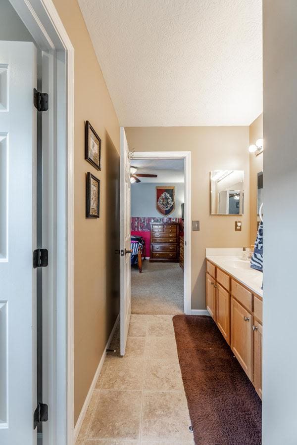 8181 Trail Lake Dr, Powell, OH 43065 - bathroom featuring a textured ceiling, ensuite bathroom, tile patterned flooring, ceiling fan, and vanity