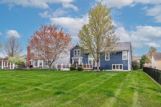 8181 Trail Lake Dr, Powell, OH 43065 - back of house with a chimney, a wooden deck, fence, and a yard