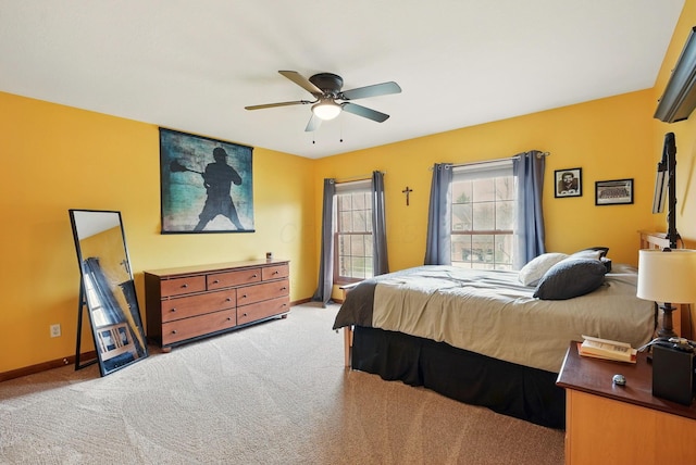 bedroom with ceiling fan, baseboards, and light carpet