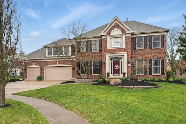 colonial inspired home with brick siding, driveway, a shingled roof, and a front lawn