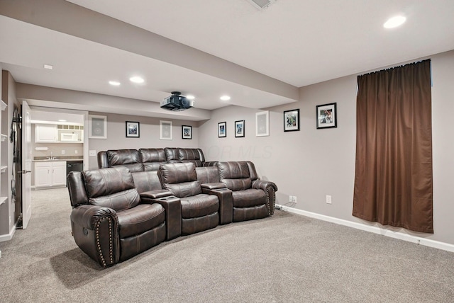 cinema room with light colored carpet, bar, and recessed lighting