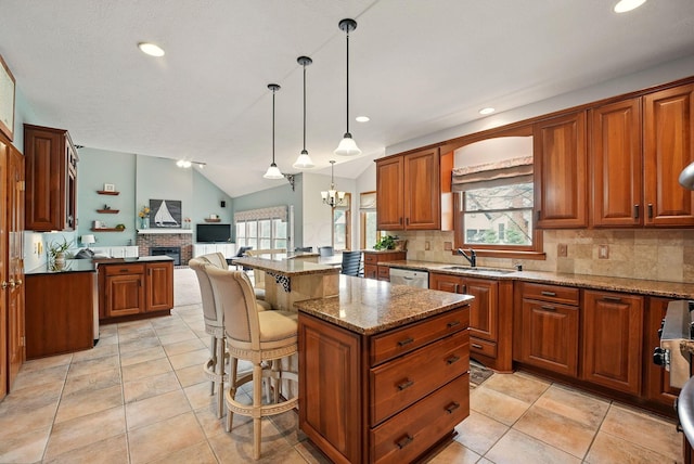 kitchen featuring open floor plan, dishwasher, a sink, and backsplash