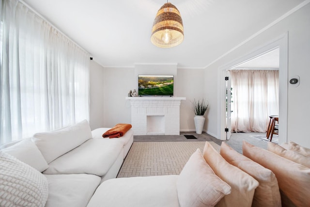 living area featuring a fireplace, baseboards, carpet floors, and a healthy amount of sunlight
