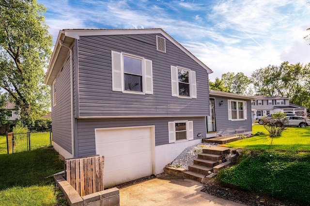 2495 Hingham Ln, Columbus, OH 43224 - tri-level home with an attached garage and driveway