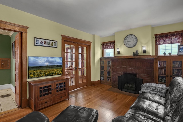 117 Fairfield Ave, Newark, OH 43055 - living area featuring baseboards, a healthy amount of sunlight, french doors, and a fireplace
