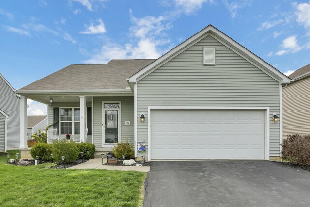 114 Hummock Dr, Etna, OH 43062 - ranch-style home featuring driveway, a porch, a garage, and a front yard
