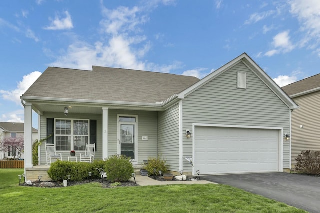 114 Hummock Dr, Etna, OH 43062 - view of front of home featuring an attached garage, driveway, a porch, and a front yard