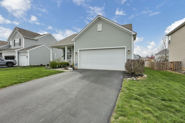 114 Hummock Dr, Etna, OH 43062 - view of front of home with fence, an attached garage, a front lawn, and driveway