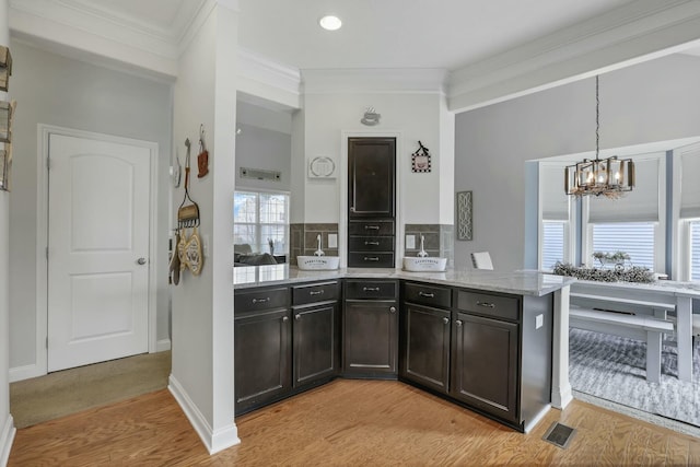 114 Hummock Dr, Etna, OH 43062 - kitchen featuring an inviting chandelier, crown molding, and light wood finished floors