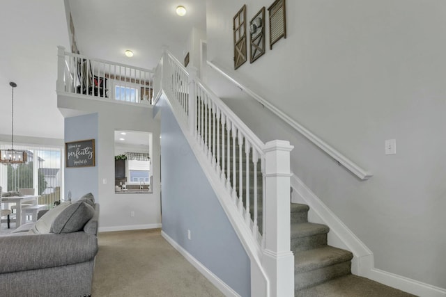 114 Hummock Dr, Etna, OH 43062 - stairs with baseboards, carpet flooring, and an inviting chandelier